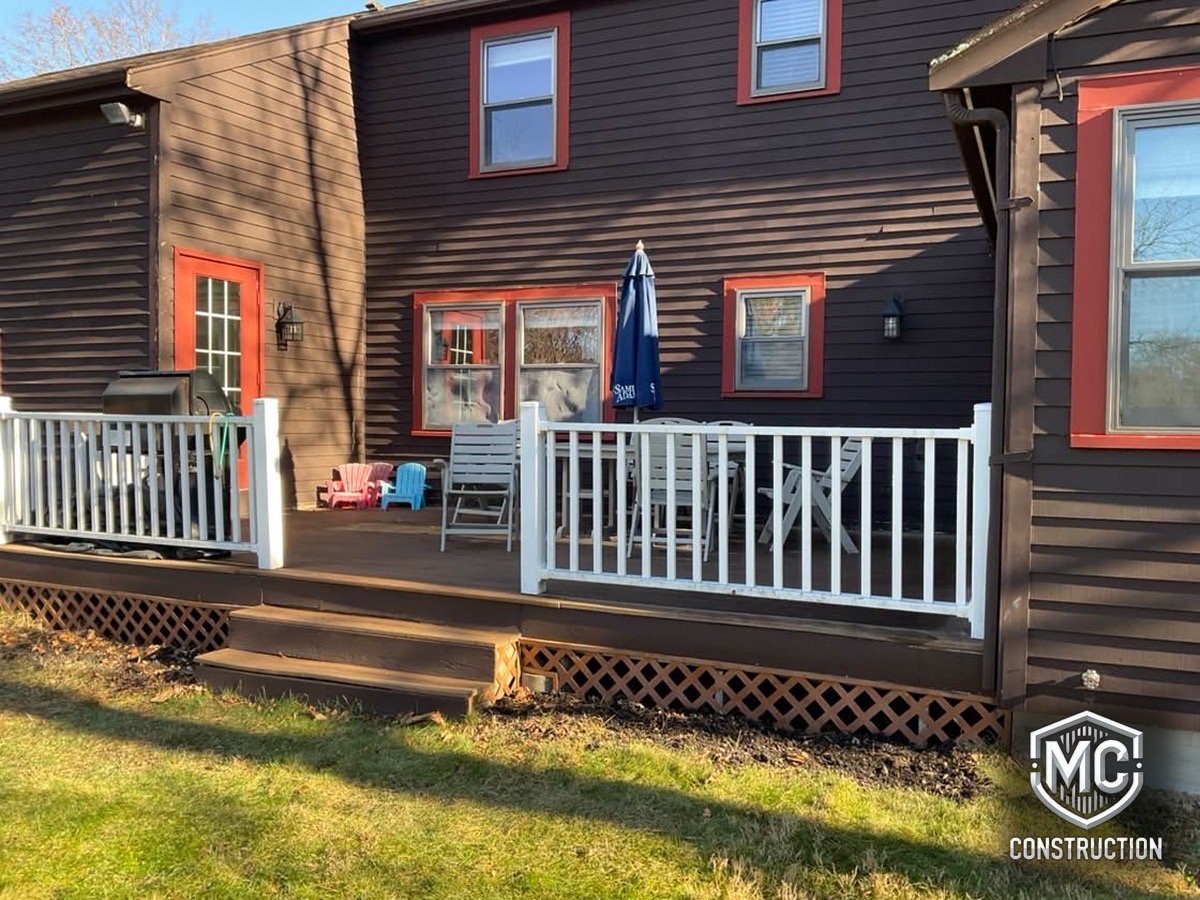 Original deck in Framingham before remodeling: worn wood decking, aging railings and lattice skirting
