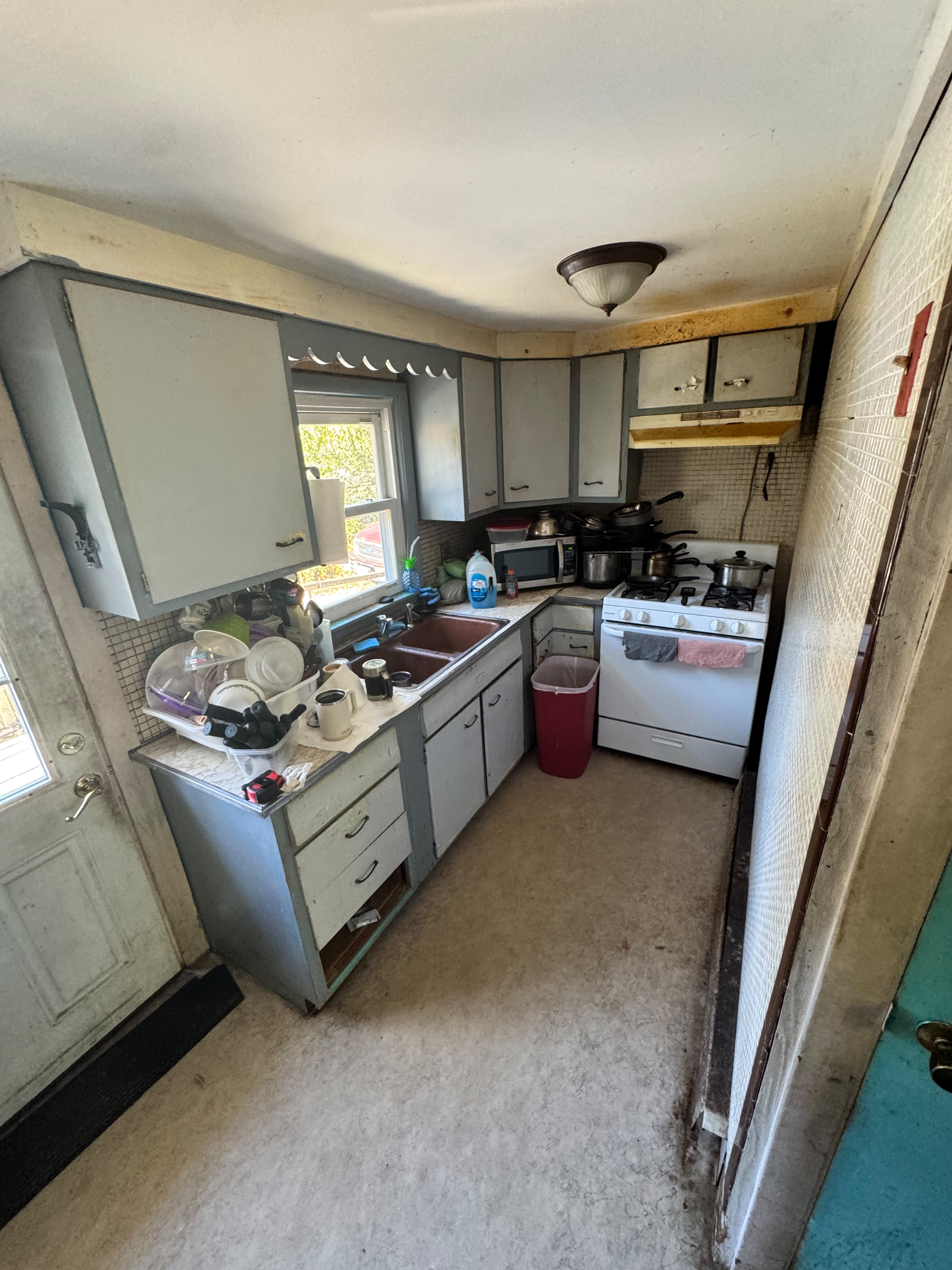 Kitchen remodeling in Boylston, MA — before: dated kitchen with worn cabinets and finishes