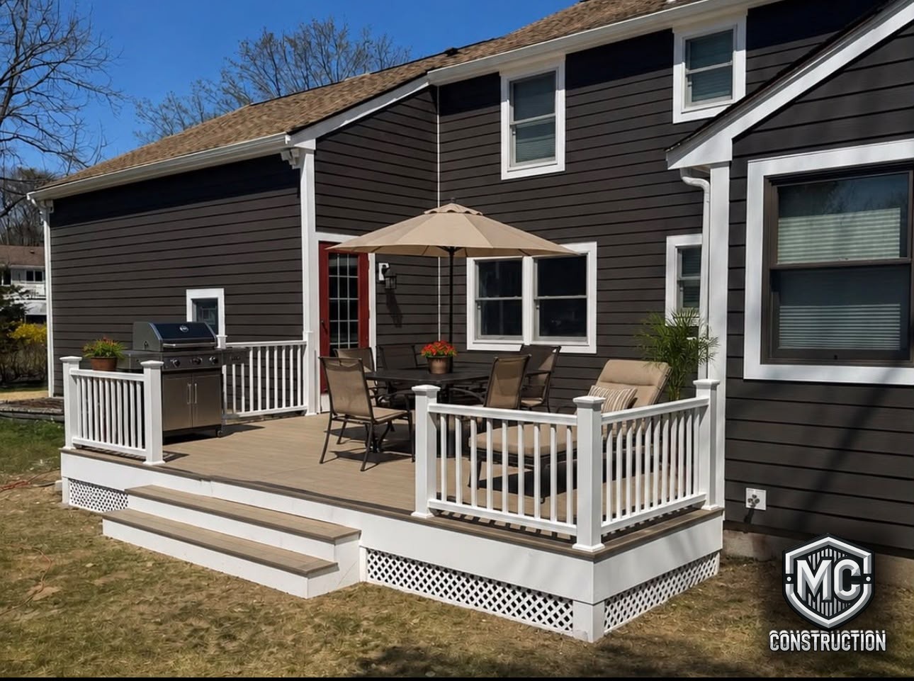 New composite deck with white vinyl railings built by MC Construction and Improvement