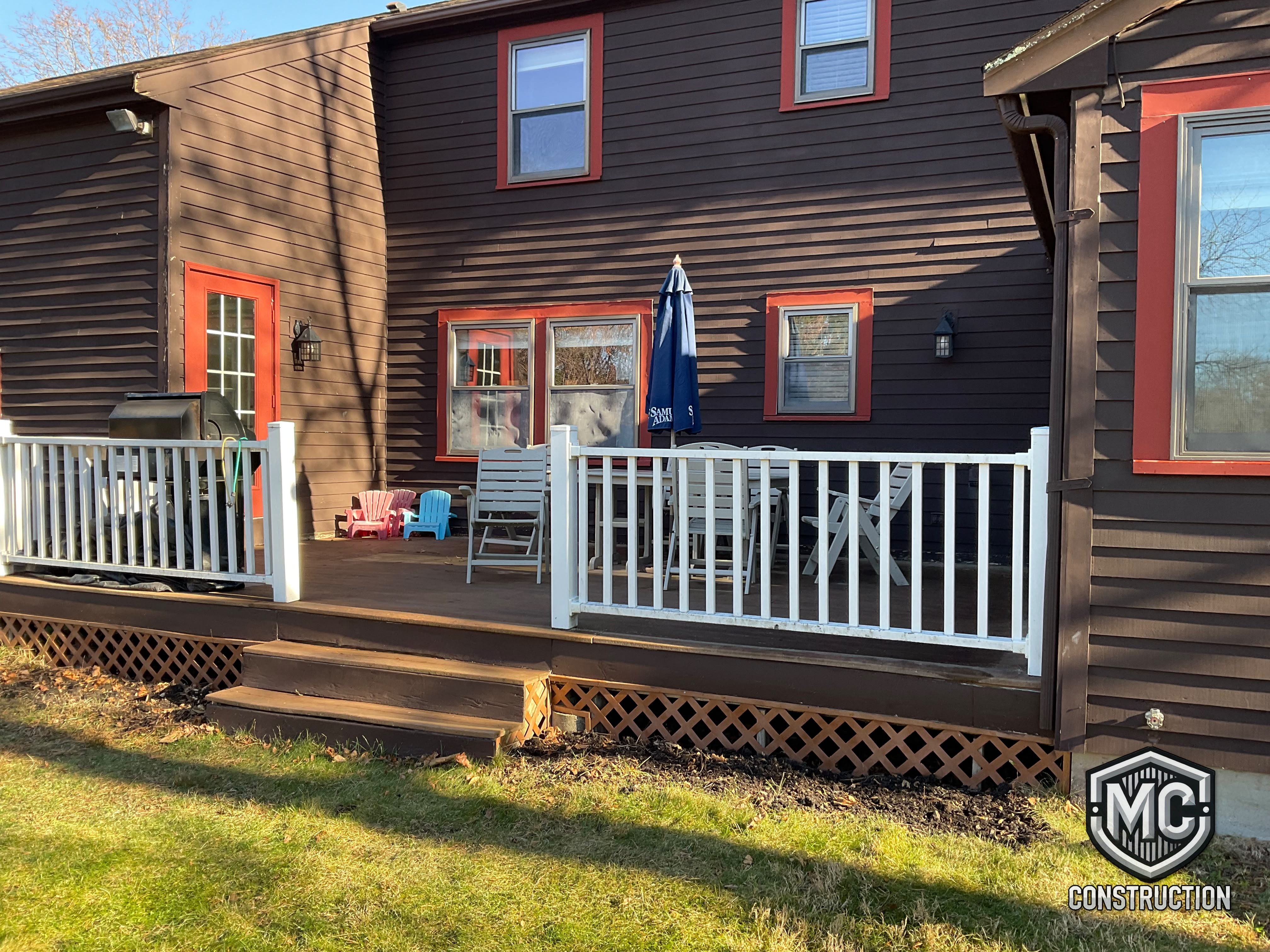 Wood deck with white railings built by MC Construction and Improvement